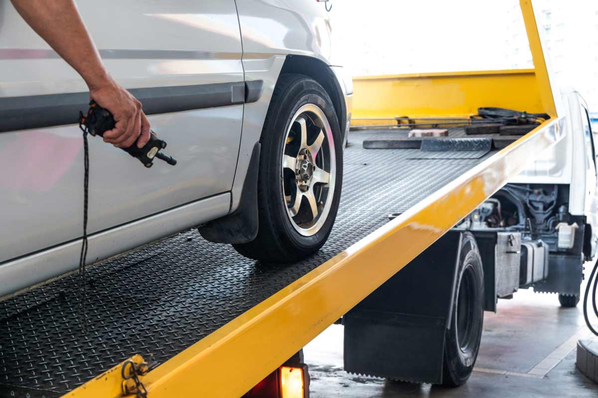 Loading White Vehicle On The Flatbed Towing Truck